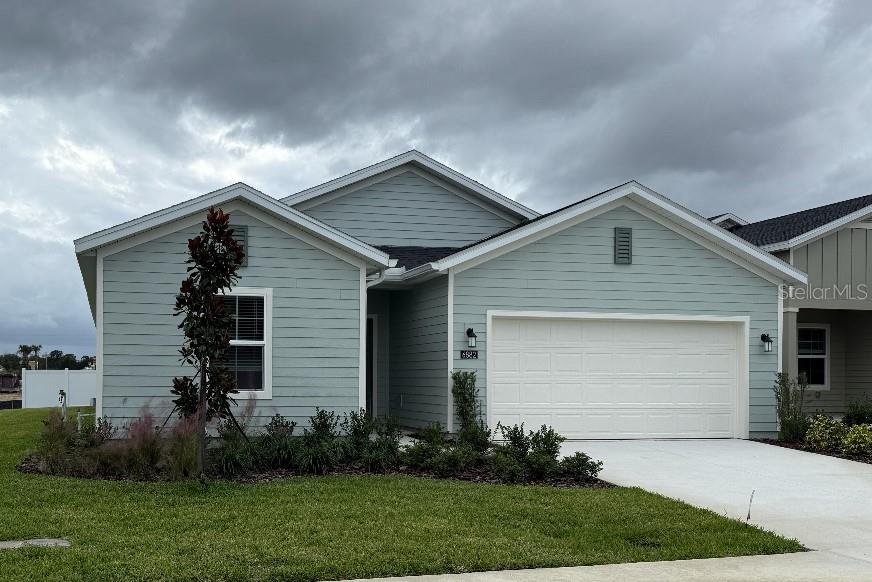 a front view of house with yard and green space
