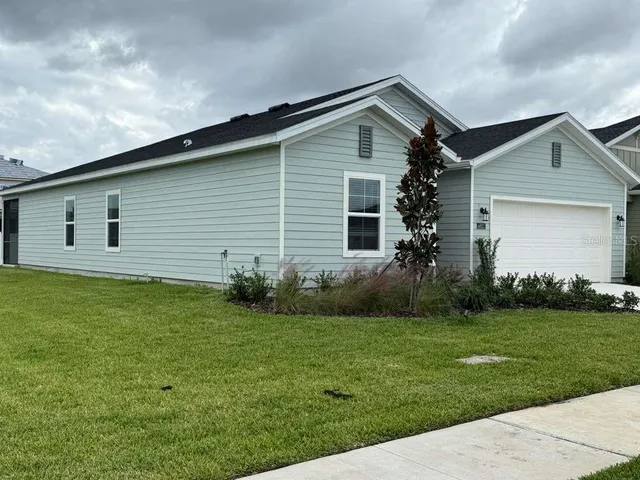 a front view of house with yard and green space