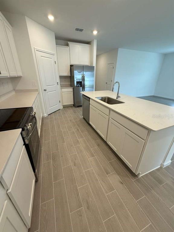6882 Southwest 89th Lane Ocala, FL 34476 - Photo 7 of 16 a kitchen with refrigerator and cabinets