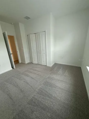 an empty room with closet area