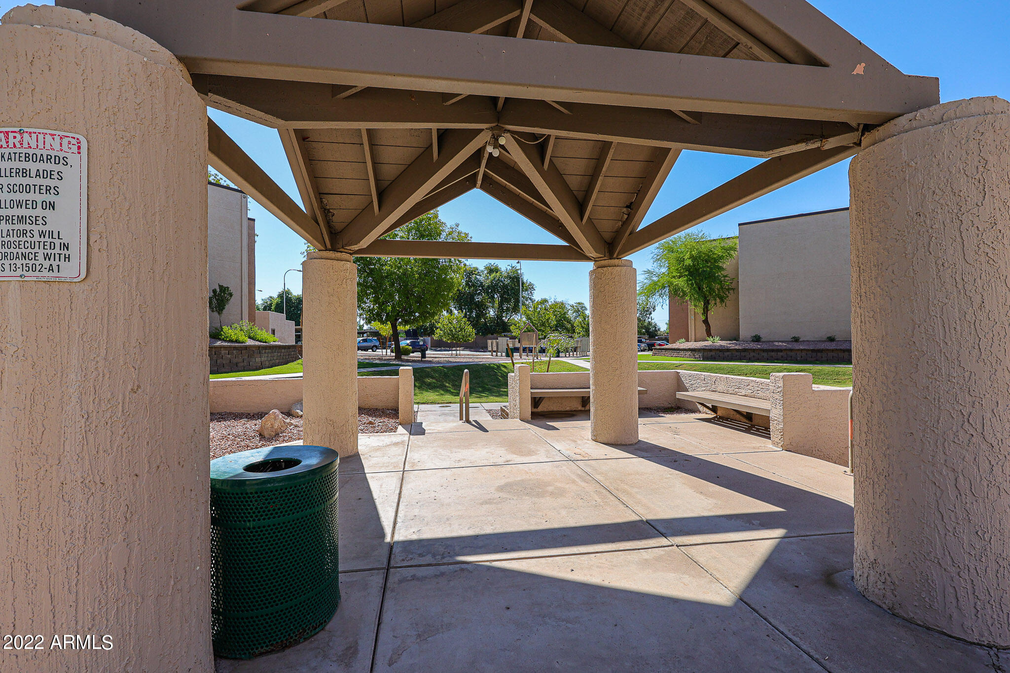 1340 North Recker Road, Unit 141 Mesa, AZ 85205 - Photo 15 of 17 a view of a patio with a table and chairs under an umbrella