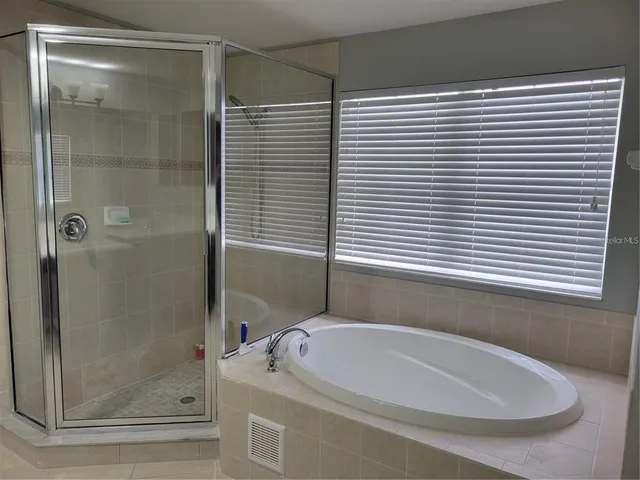 a bathroom with a bathtub and a shower