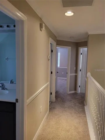 a view of a hallway with closet and wooden floor