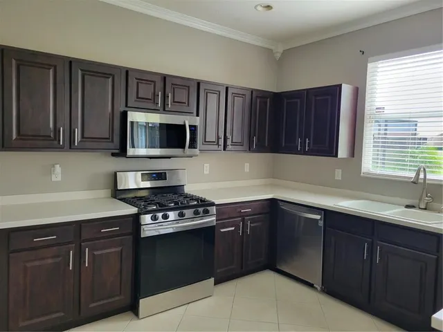 a kitchen with cabinets a sink and appliances