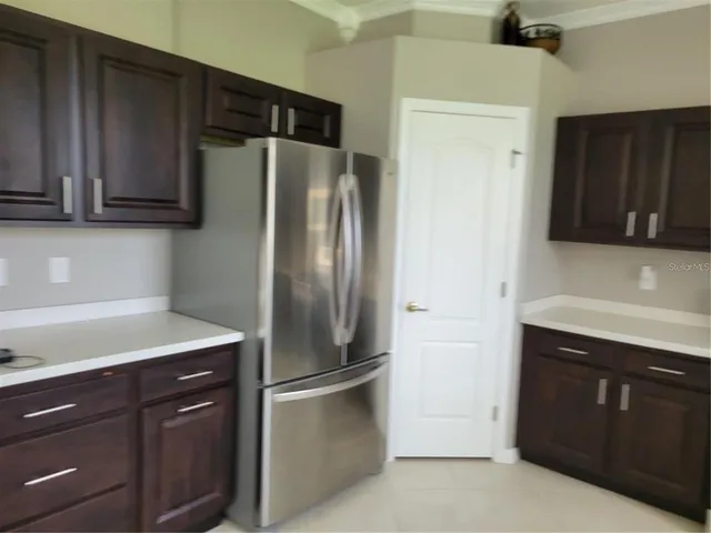 a kitchen with stainless steel appliances granite countertop a refrigerator and a sink