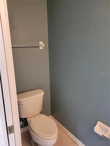 a white toilet sitting next to a shower