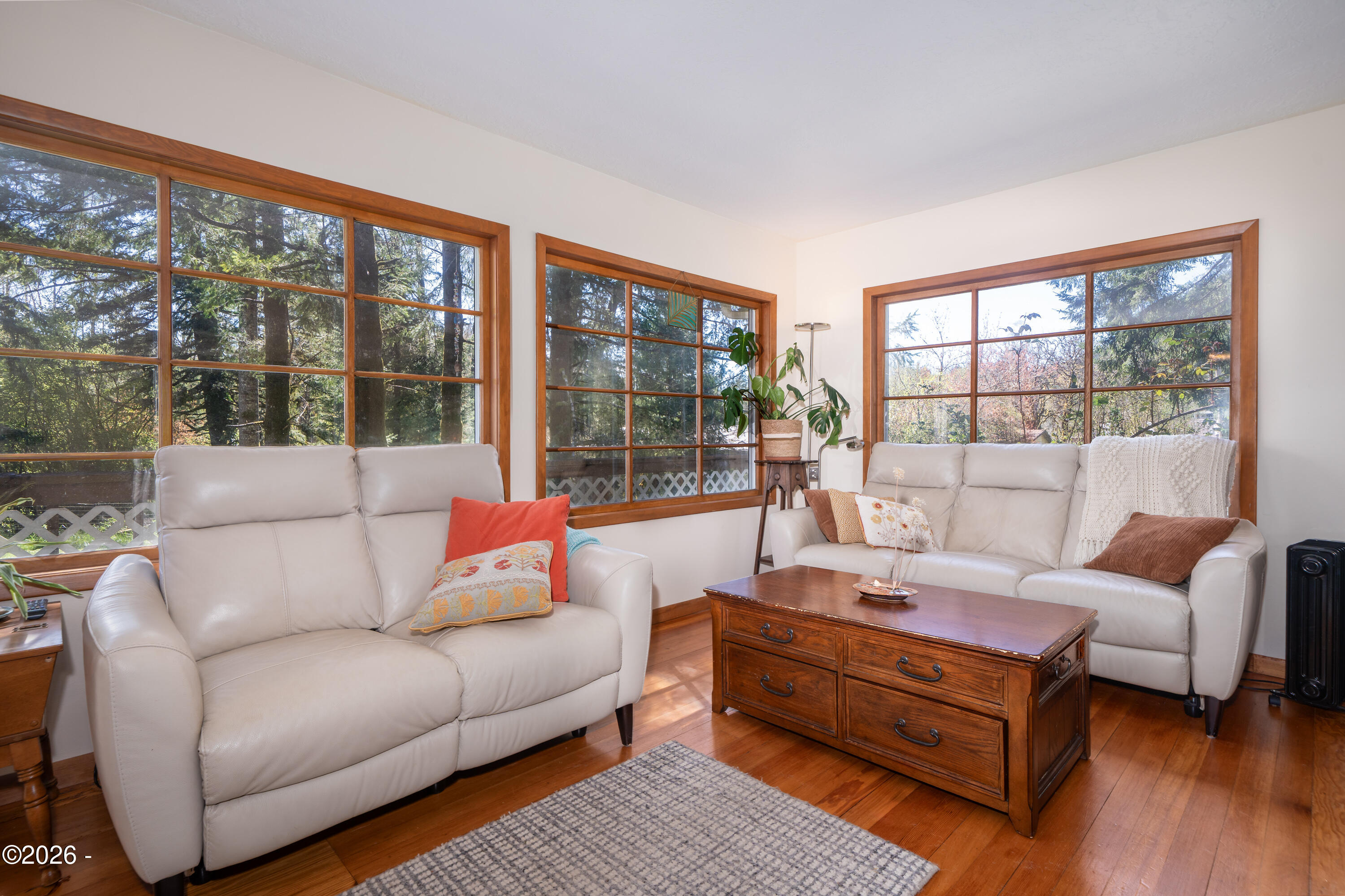 258 Neal Loop Toledo, OR 97391 - Photo 12 of 53 Original 1910's windows have been professionally refurbished in the past, adding years of life and protection to these beautiful picture frame windows (storm window surrounds each from outside)