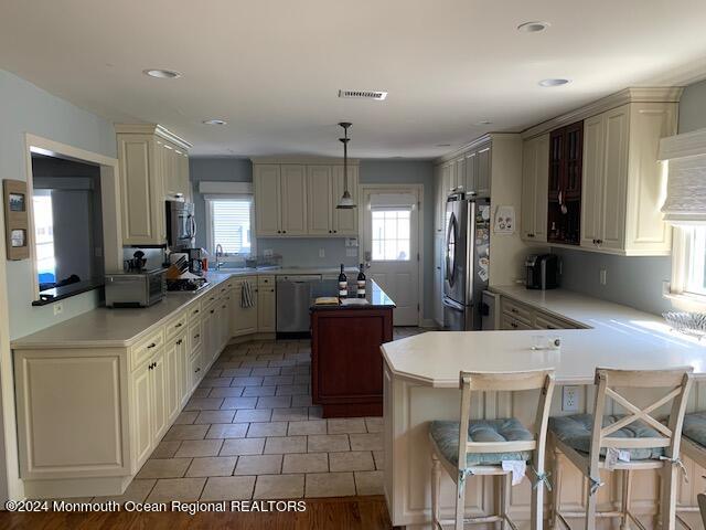 a large kitchen with kitchen island granite countertop lots of counter top space and stainless steel appliances
