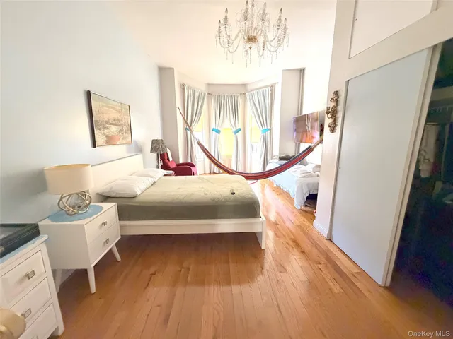 a bedroom with a bed and a chandelier