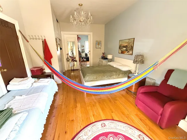 a bed room with a bed and a chandelier