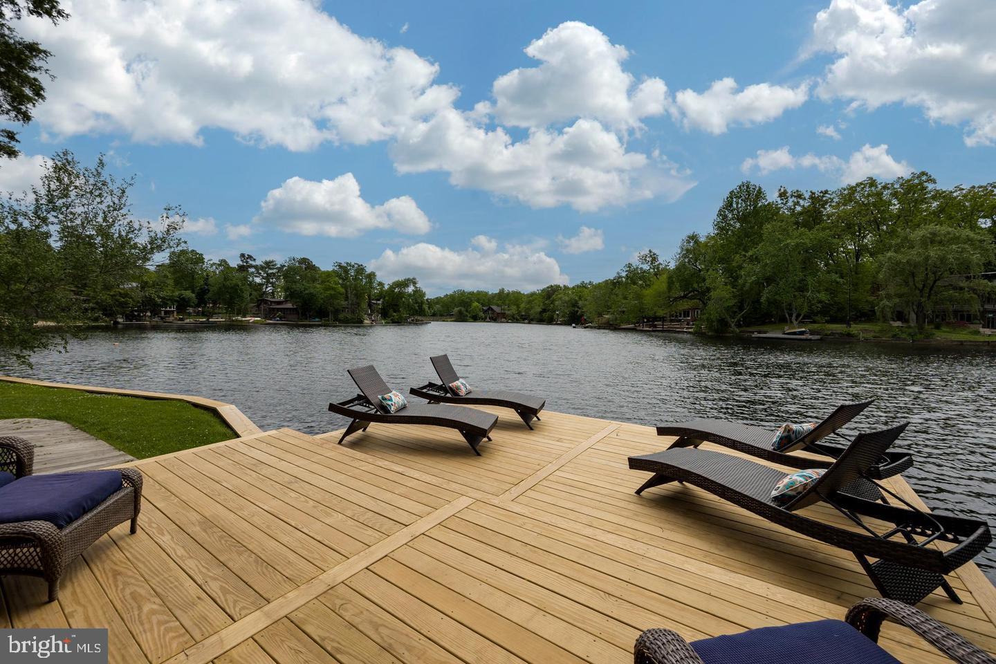 a view of a lake with outdoor seating and lake