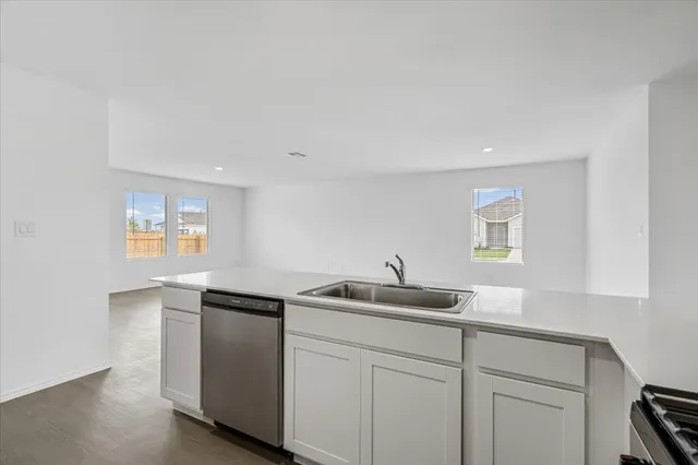 a kitchen with stainless steel appliances a refrigerator a stove a microwave and cabinets