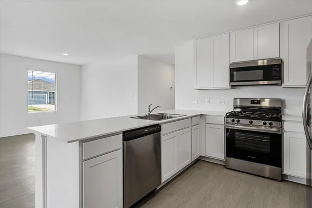 a view of a kitchen with a sink and a window