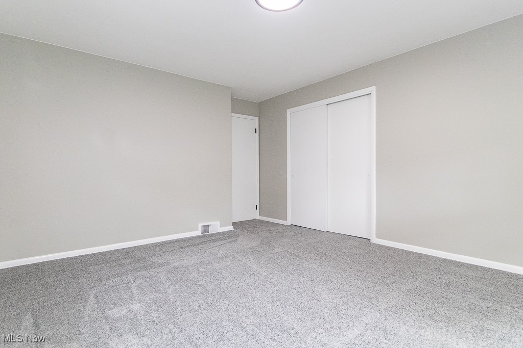 5683 Cherokee Road Cleveland, OH 44124 - Photo 13 of 35 Unfurnished bedroom with a closet and carpet flooring
