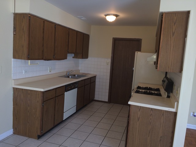 17 Churn Road, Unit 23 Matteson, IL 60443 - Photo 5 of 17 a kitchen with a sink a stove and a refrigerator