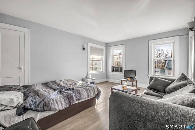 a bedroom with bed and a window