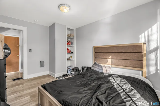 a bed sitting in a room next to a window