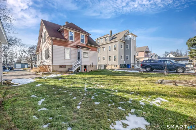 a front view of a house with a yard table and chairs