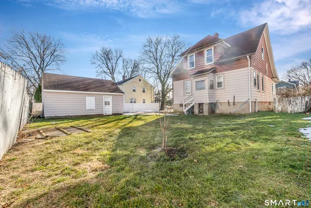 a house view with swimming pool in front of it