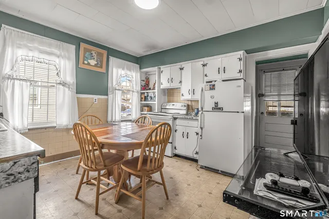 a dining room with furniture and window