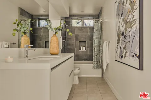 a bedroom with a bed and a night stand