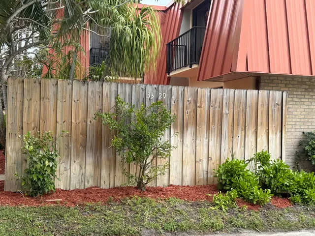 a view of a backyard with potted plants