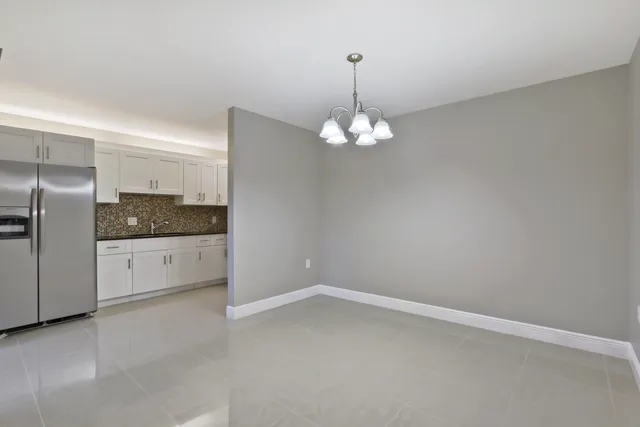 a view of an empty room with a chandelier