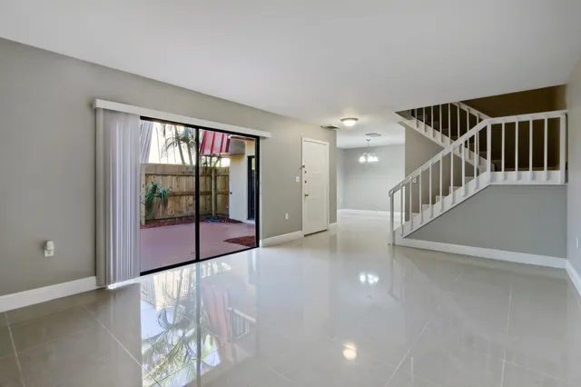 a view of staircase with white walls and windows