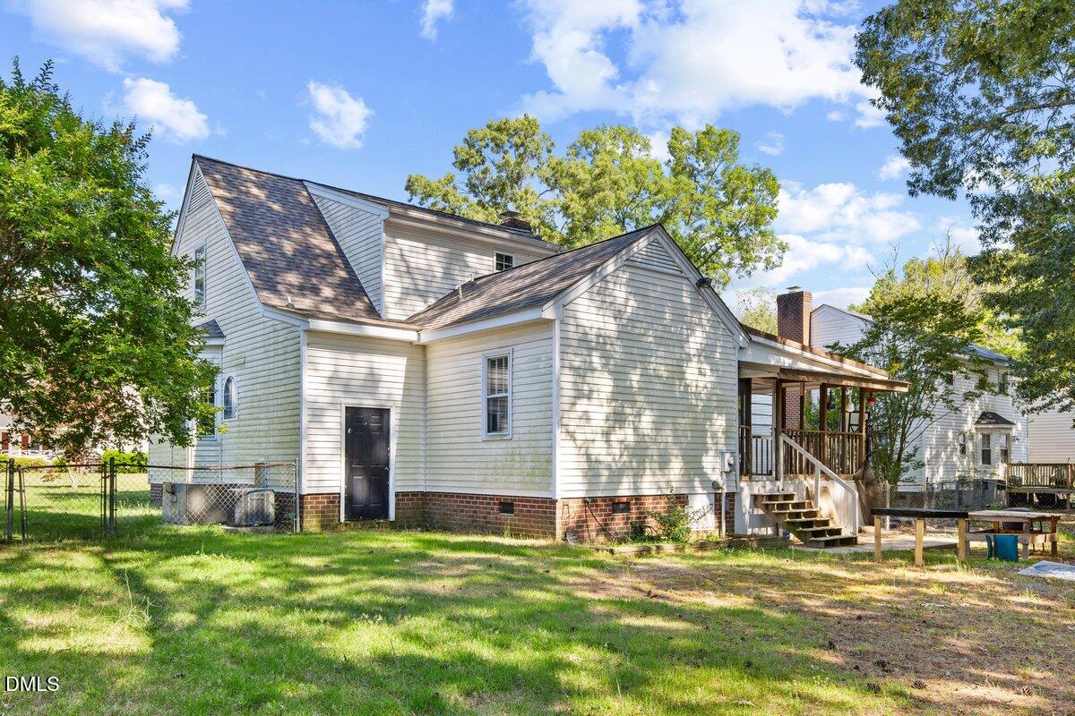 3812 Providence Road Rocky Mount, NC 27803 - Photo 16 of 18 a backyard of a house with lots of green space and fountain