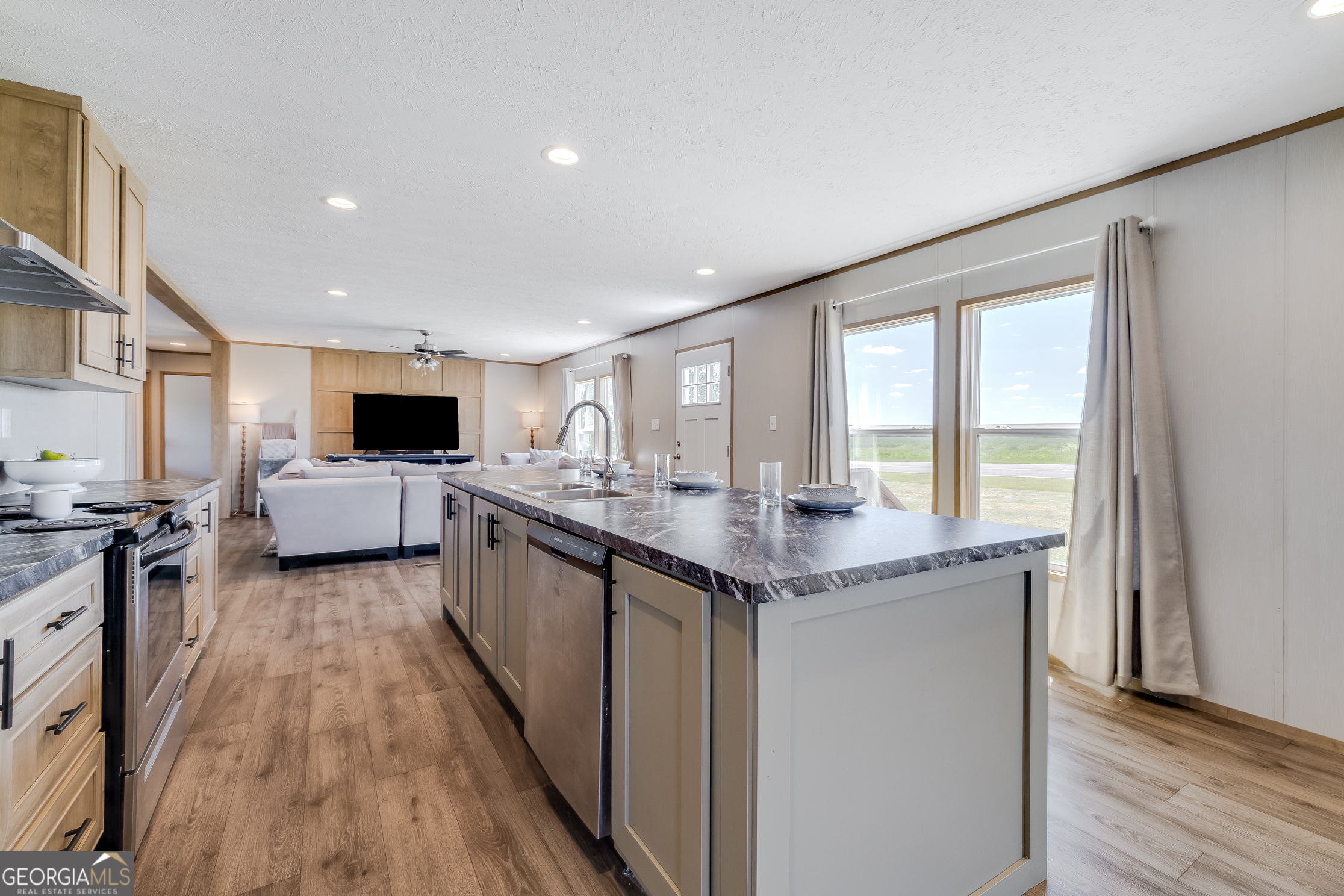 559 Evergreen Church Road Cobbtown, GA 30420 - Photo 12 of 40 a large kitchen with stainless steel appliances granite countertop a lot of counter space and wooden floor