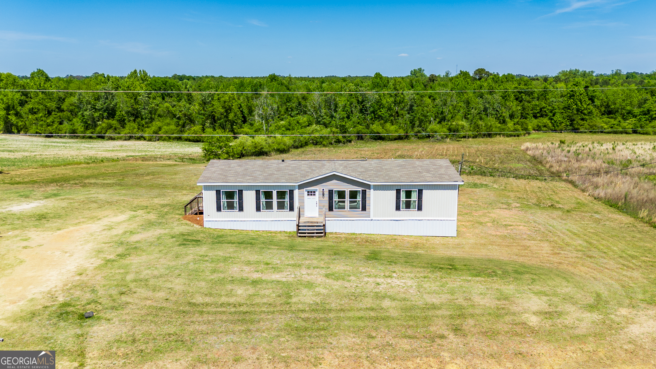 559 Evergreen Church Road Cobbtown, GA 30420 - Photo 2 of 40 a front view of a house with a yard