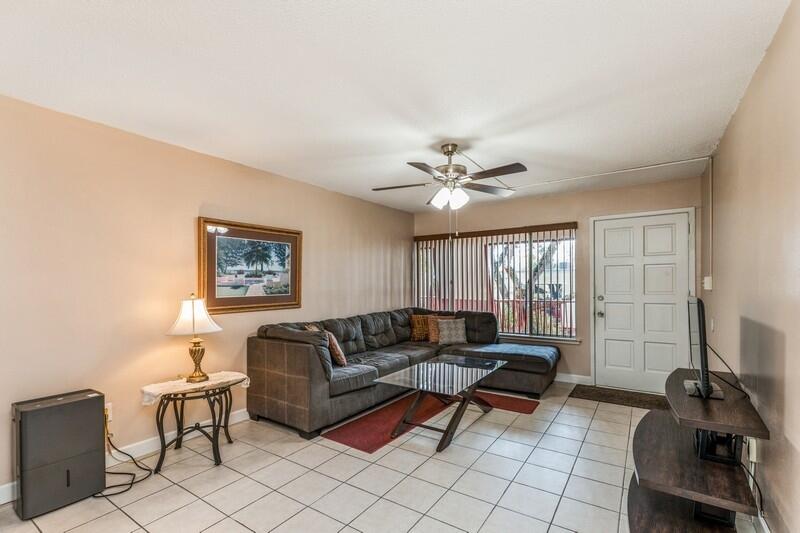 210 Pelham Road, Unit 201A Fort Walton Beach, FL 32547 - Photo 12 of 38 a living room with furniture and floor to ceiling window