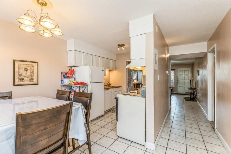210 Pelham Road, Unit 201A Fort Walton Beach, FL 32547 - Photo 13 of 38 a view of a dining room with furniture and chandelier