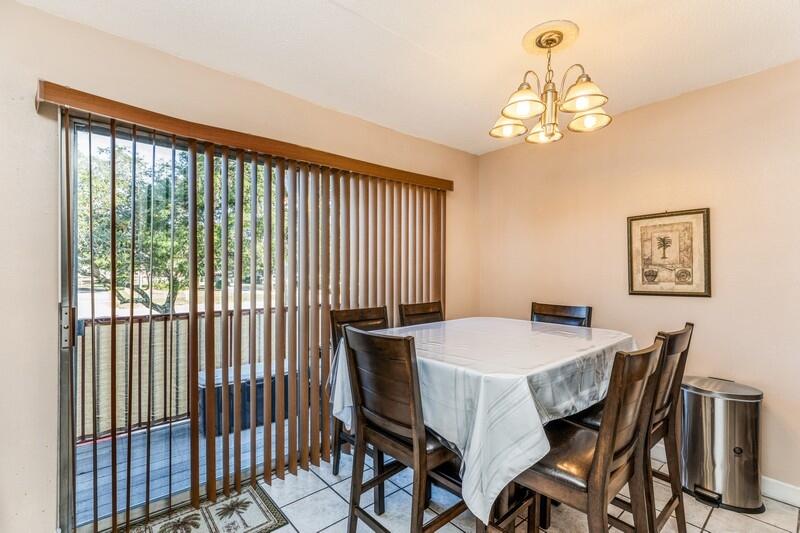 210 Pelham Road, Unit 201A Fort Walton Beach, FL 32547 - Photo 14 of 38 a view of a dining room with furniture a chandelier and wooden floor