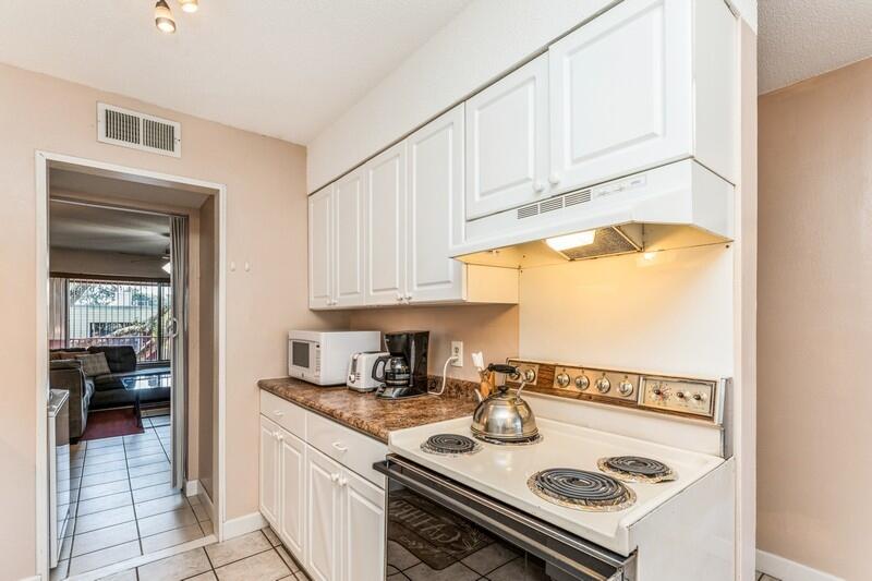210 Pelham Road, Unit 201A Fort Walton Beach, FL 32547 - Photo 15 of 38 a kitchen with a stove and a white cabinet