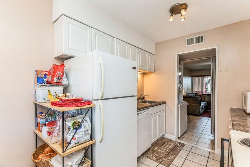 210 Pelham Road, Unit 201A Fort Walton Beach, FL 32547 - Photo 16 of 38 a white refrigerator freezer sitting inside of a kitchen