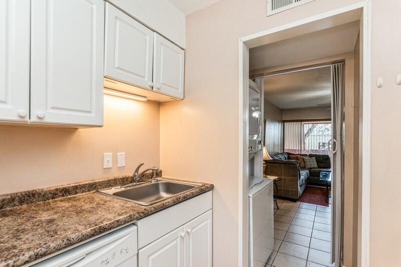 210 Pelham Road, Unit 201A Fort Walton Beach, FL 32547 - Photo 17 of 38 a kitchen with a sink and cabinets