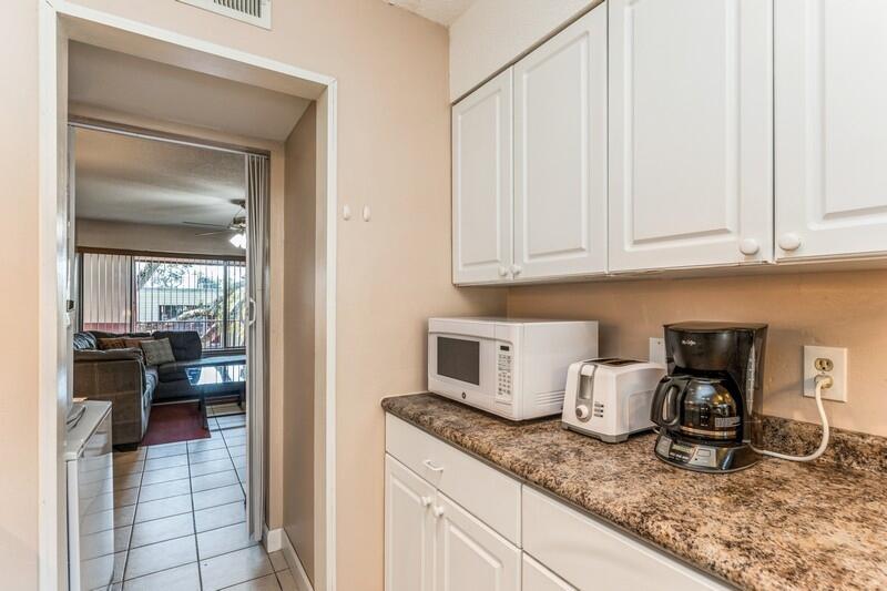 210 Pelham Road, Unit 201A Fort Walton Beach, FL 32547 - Photo 18 of 38 a kitchen with granite countertop a sink and white cabinets