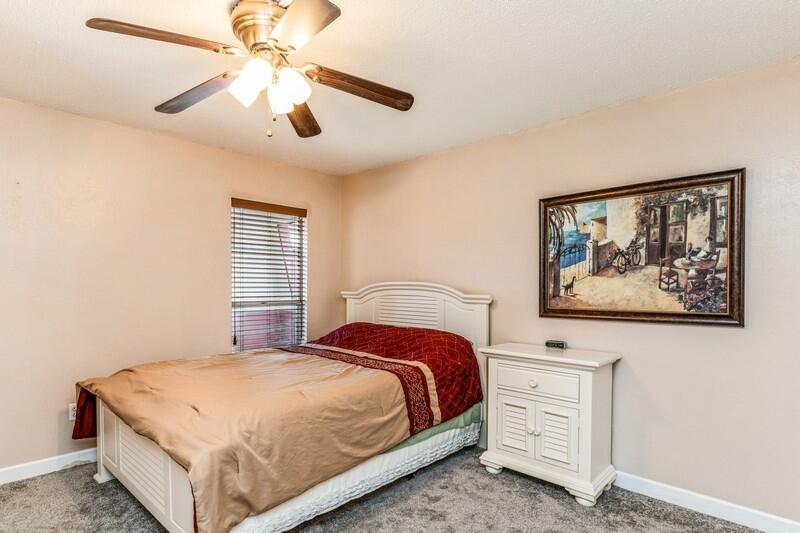 210 Pelham Road, Unit 201A Fort Walton Beach, FL 32547 - Photo 22 of 38 a bedroom with a bed and a painting on the wall