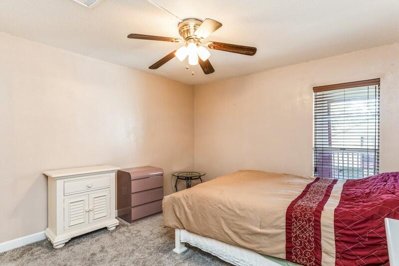210 Pelham Road, Unit 201A Fort Walton Beach, FL 32547 - Photo 23 of 38 a bedroom with a bed and a chandelier