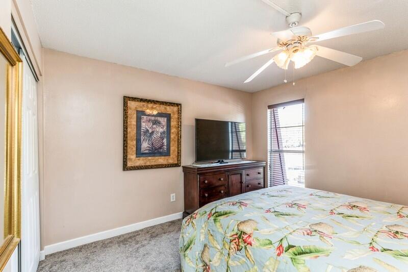 210 Pelham Road, Unit 201A Fort Walton Beach, FL 32547 - Photo 24 of 38 a bedroom with a bed and a flat screen tv