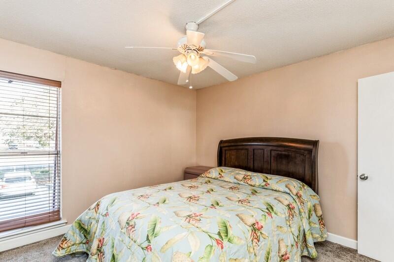 210 Pelham Road, Unit 201A Fort Walton Beach, FL 32547 - Photo 25 of 38 a bedroom with a bed and a chandelier