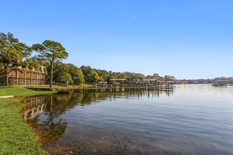 210 Pelham Road, Unit 201A Fort Walton Beach, FL 32547 - Photo 37 of 38 a view of a lake with houses in front of it