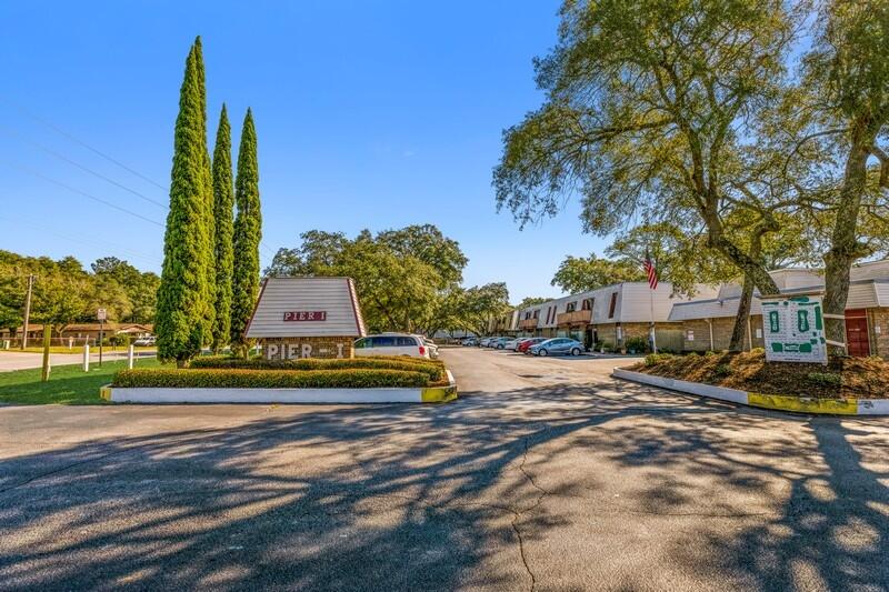 210 Pelham Road, Unit 201A Fort Walton Beach, FL 32547 - Photo 5 of 38 a view of a yard with plants and a fountain
