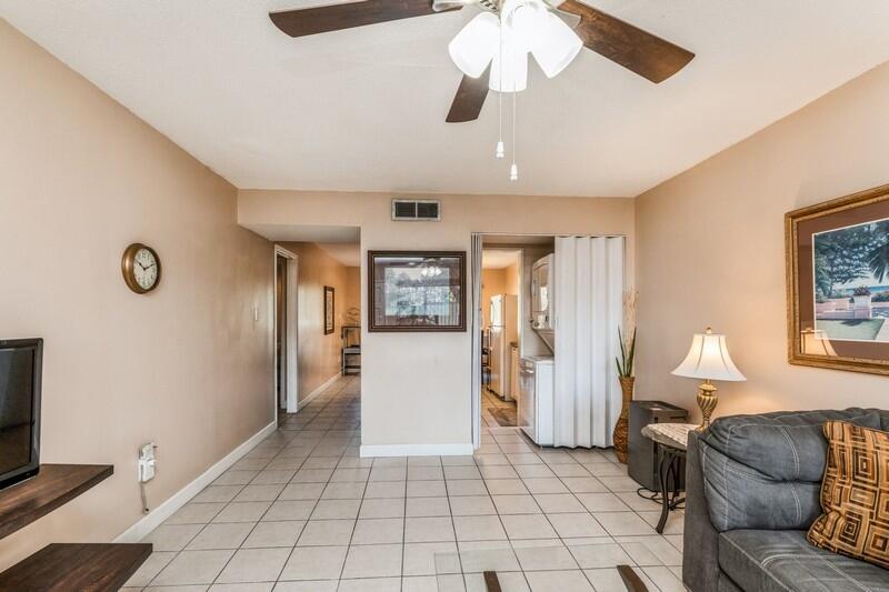 210 Pelham Road, Unit 201A Fort Walton Beach, FL 32547 - Photo 9 of 38 a living room with furniture and a chandelier