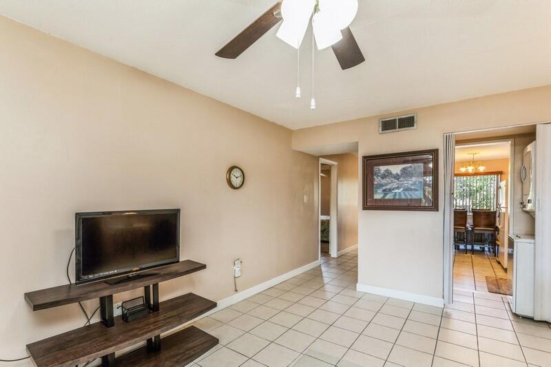 210 Pelham Road, Unit 201A Fort Walton Beach, FL 32547 - Photo 10 of 38 a living room with furniture and a flat screen tv