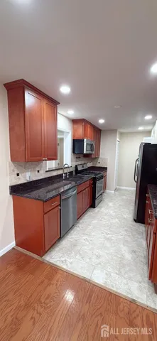 a kitchen with stainless steel appliances granite countertop a stove sink and microwave