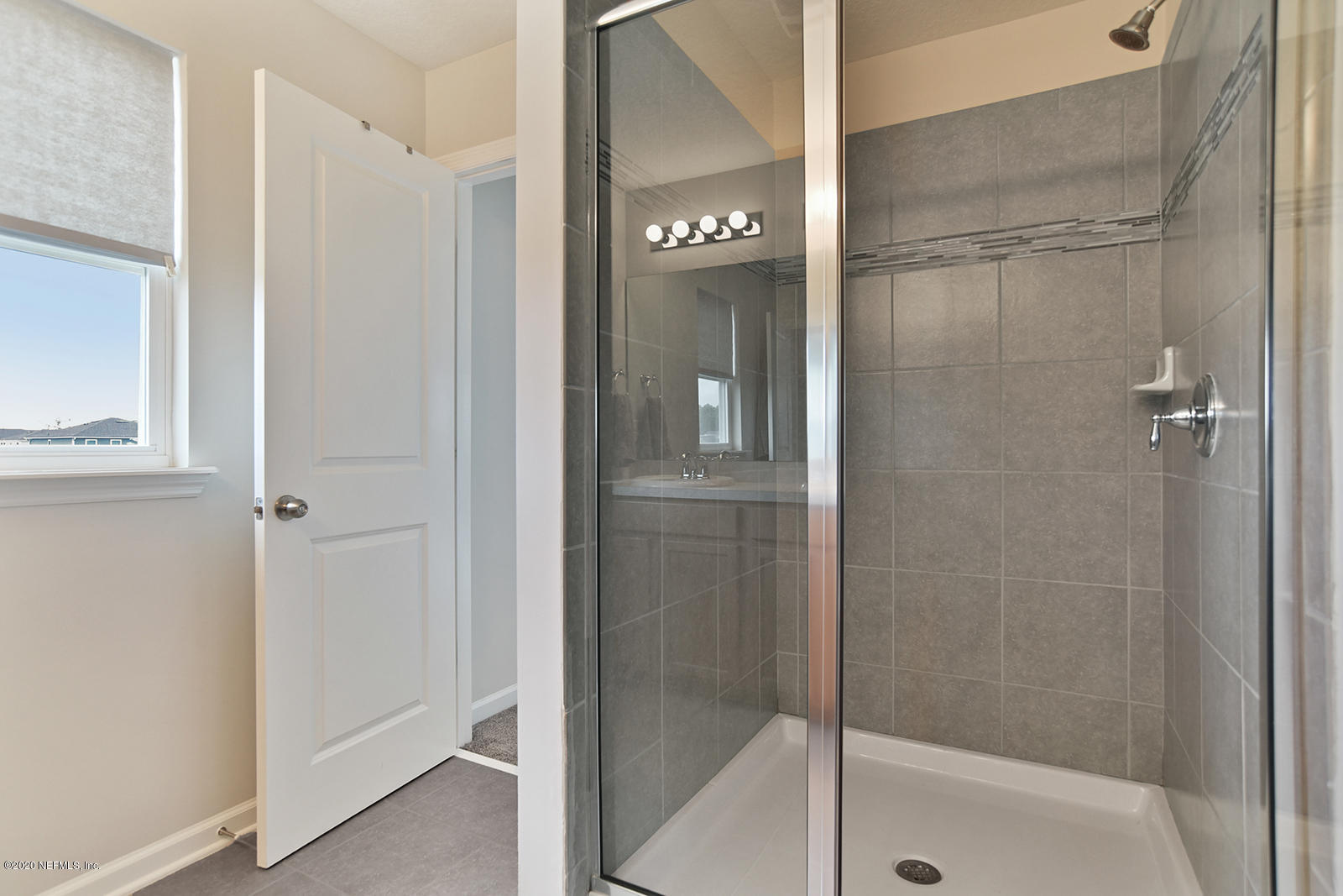 14780 Trellis Street Jacksonville, FL 32258 - Photo 19 of 29 a bathroom with a glass shower door