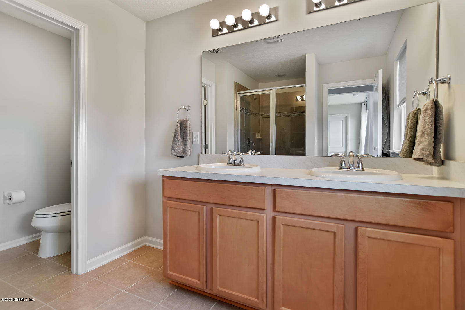 14780 Trellis Street Jacksonville, FL 32258 - Photo 20 of 29 a bathroom with a double vanity sink and a toilet