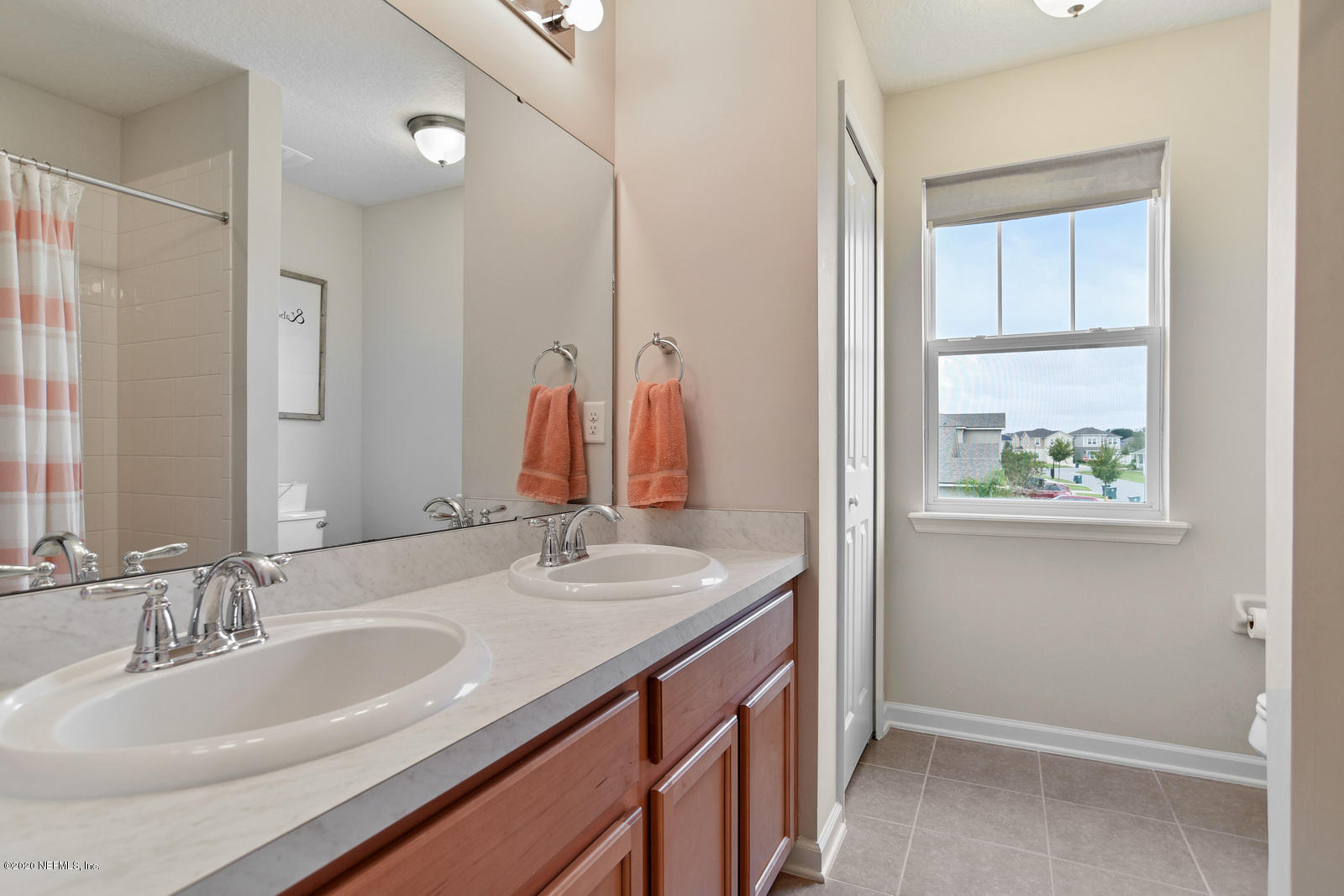 14780 Trellis Street Jacksonville, FL 32258 - Photo 22 of 29 a bathroom with a double vanity sink and a mirror